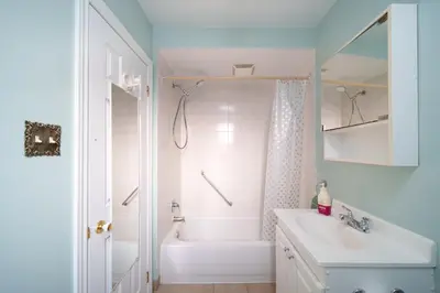 a bathroom with a tub and a sink and a shower at 3 bedrooms in Brossard,mins to REM station,hwy in Brossard