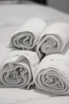 a pile of towels laying on a bed at Stunning 2 Bedroom Downtown Montreal in Montréal