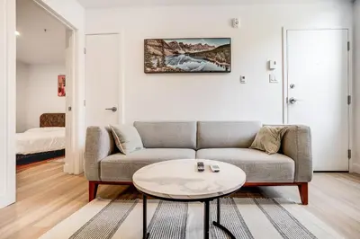 a living room with a couch and a table at Stunning 2 Bedroom Downtown Montreal in Montréal