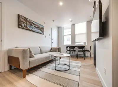 a living room with a couch and a table at Stunning 2 Bedroom Downtown Montreal in Montréal
