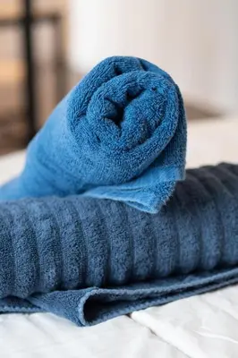 a blue towel sitting on top of a bed at Elegant Studio in DT MTL AC, Wi-Fi in Montréal