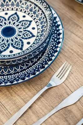 a blue and white plate and a fork on a table at Elegant Studio in DT MTL AC, Wi-Fi in Montréal