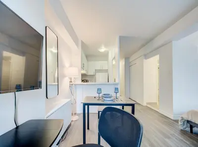 a dining room with a table and chairs in a room at Elegant Studio in DT MTL AC, Wi-Fi in Montréal