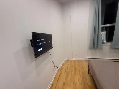 a flat screen tv on a wall in a room at Well located studio apartment with parking near downtown Montreal in Montréal