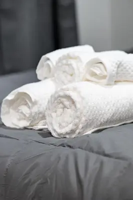 a group of towels sitting on top of a bed at Amazing 1Bed Downtown Mtl in Montréal