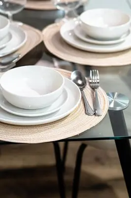 a glass table with plates and silverware on it at Amazing 1Bed Downtown Mtl in Montréal