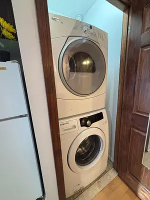 a washing machine and a washer and dryer in a room at Sunrise Haven in Montréal