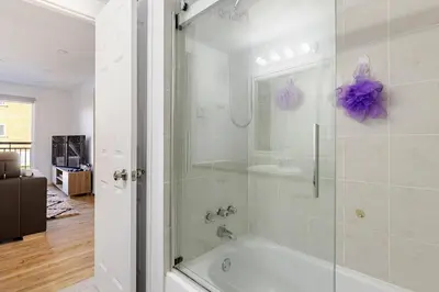 a bathroom with a shower and a bath tub at Verone 4 Appartement 4,5 Meublé 2ch Laval, Canada in Laval