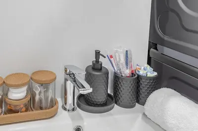a counter top with a toothbrush holder and toothbrushes at 4BR Penthouse - Parking - 2 King & 2 Queen in Montréal