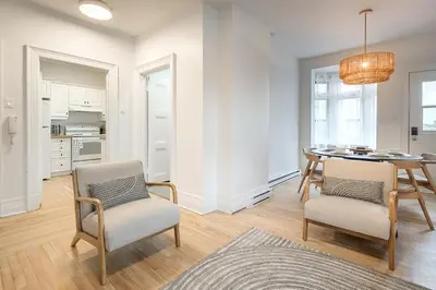 a kitchen and dining room with a table and chairs at 4BR Penthouse - Parking - 2 King & 2 Queen in Montréal