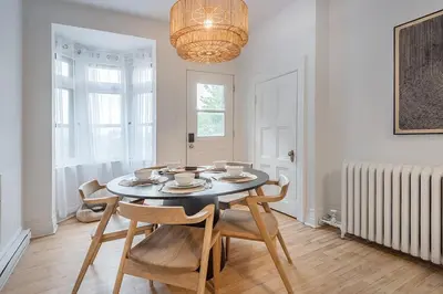 a dining room with a table with chairs and a chandelier at 4BR Penthouse - Parking - 2 King & 2 Queen in Montréal