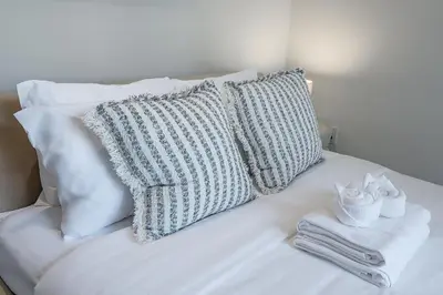 a white couch with pillows and towels on it at Downtown Core - Ultra Modern 1 Bedroom Apartment in Montréal