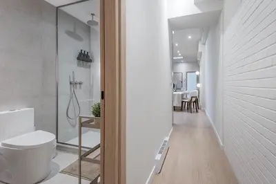 a bathroom with a toilet and a walk in shower at Downtown Core - Ultra Modern 1 Bedroom Apartment in Montréal