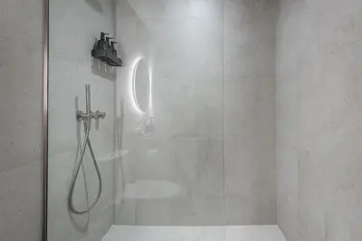 a bathroom with a shower with a glass door at Downtown Core - Ultra Modern 1 Bedroom Apartment in Montréal