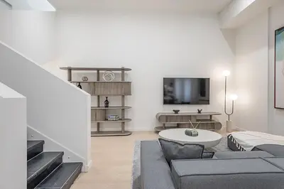 a living room with a couch and a table at Luxury 4BR 3BA Penthouse with Private Terrace in Montréal