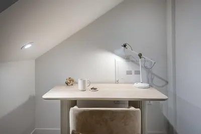 a desk with a lamp and a chair in a room at Luxury 4BR 3BA Penthouse with Private Terrace in Montréal