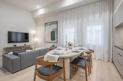 a living room with a table and a couch at Luxury 4BR 3BA Penthouse with Private Terrace in Montréal