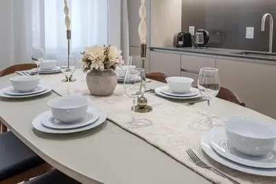 a table with plates and bowls and glasses on it at Luxury 4BR 3BA Penthouse with Private Terrace in Montréal
