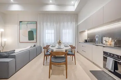 a kitchen and living room with a table and a couch at Luxury 4BR 3BA Penthouse with Private Terrace in Montréal