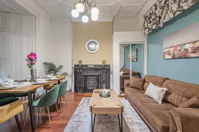 a living room with a couch and a table at Spacious 3BR Downtown - 2 Queen & Bunk & Sofa Bed in Montréal