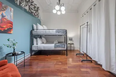 a bedroom with a bed in a room at Spacious 3BR Downtown - 2 Queen & Bunk & Sofa Bed in Montréal