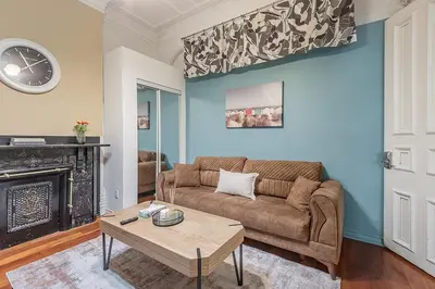 a living room with a couch and a table at Spacious 3BR Downtown - 2 Queen & Bunk & Sofa Bed in Montréal