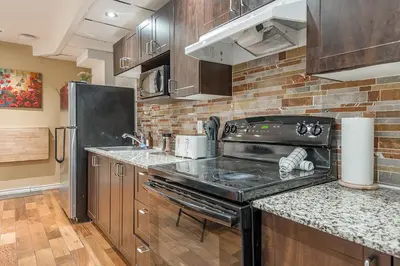 a kitchen with a stove and a counter top at Spacious 2BR Downtown - Vintage Charm Sleeps 10 in Montréal