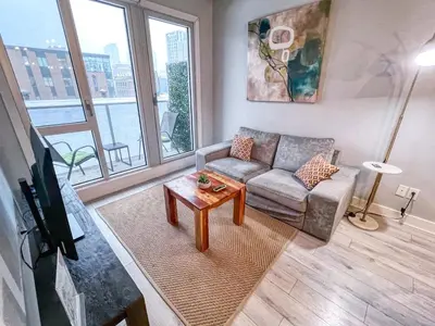 a living room with a couch and a table at Downtown Elite Residences in Montréal