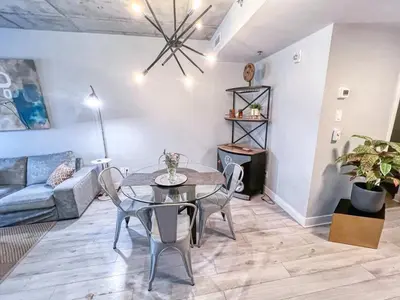 a living room with a table and chairs and a couch at Downtown Elite Residences in Montréal
