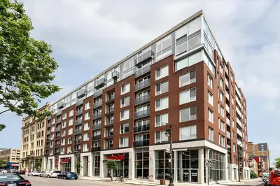 a large brick building on a city street at Downtown Elite Residences in Montréal