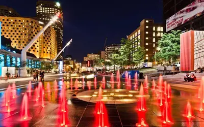 a fire fountain in the middle of a city at night at Downtown Elite Residences in Montréal
