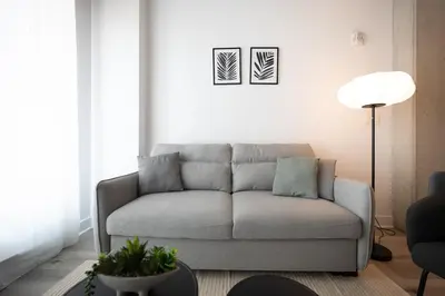 a living room with a couch and a lamp at Charming 1BR Old Port - Sofa Bed - Balcony with City View in Montréal