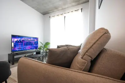 a living room with a couch and a flat screen tv at Charming 1BR Old Port - Sofa Bed - Balcony with City View in Montréal