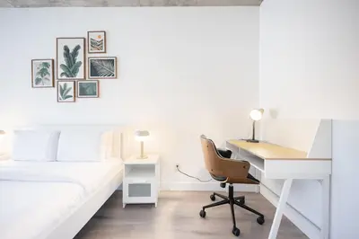 a bedroom with a desk and a bed and a desk at Spacious Apartment in Old Port Montreal in Montréal