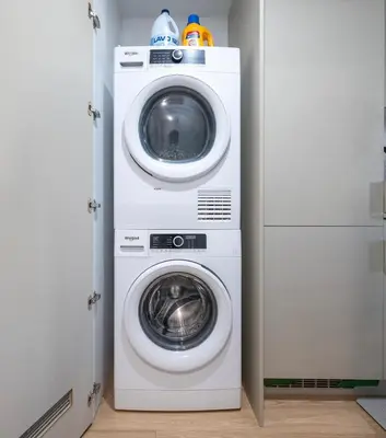 a washing machine and a washer in a closet at Chic Hideaway - Downtown Hotspot in Montréal