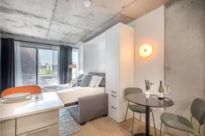 a living room with a couch and a table at Urban Hideout - Downtown Haven in Montréal
