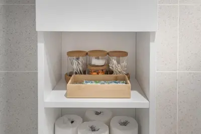 a shelf in a bathroom with a wooden box at Urban Hideout - Downtown Haven in Montréal