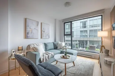 a living room with a blue couch and a table at Old Port Upscale - Free Indoor Parking in Montréal
