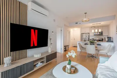 a living room with a tv with the letter n on it at Old Port Upscale - Free Indoor Parking in Montréal