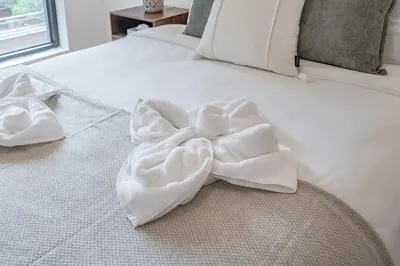 a white bed with a bow on it at Old Port Upscale - Free Indoor Parking in Montréal