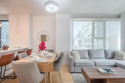 a living room with a table and a couch at Corner 2BR Old Port - Free Indoor Parking in Montréal
