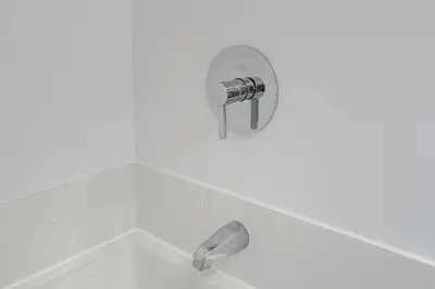 a shower with a silver faucet in a bathroom at Corner 2BR Old Port - Free Indoor Parking in Montréal