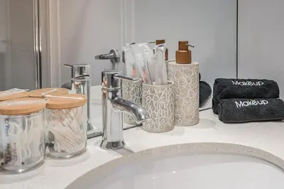 a bathroom counter with toothbrushes and other items on it at Corner 2BR Old Port - Free Indoor Parking in Montréal