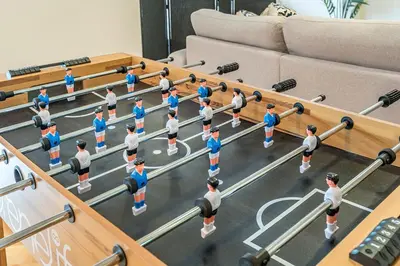 a group of people standing in a wrestling match in a living room at Stylish Loft Retreat - Prime Location - Sleeps 8 in Montréal