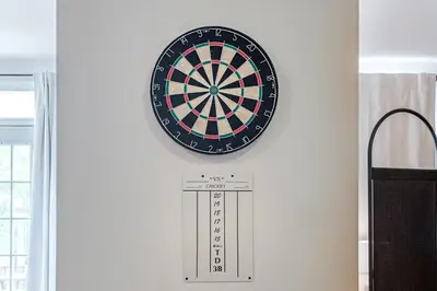 a dart board on a wall with a dartboard at Stylish Loft Retreat - Prime Location - Sleeps 8 in Montréal