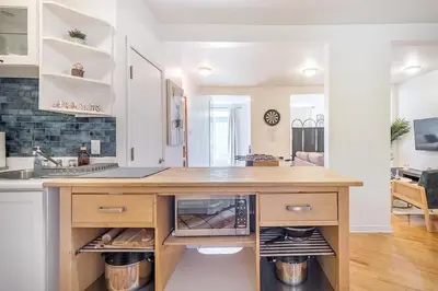 a kitchen with a counter with an open oven at Stylish Loft Retreat - Prime Location - Sleeps 8 in Montréal