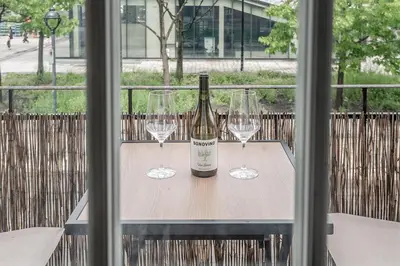 a bottle of wine and two glasses on a table at Stylish Loft Retreat - Prime Location - Sleeps 8 in Montréal