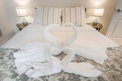 two swans making a heart on a bed at Stylish Loft Retreat - Prime Location - Sleeps 8 in Montréal