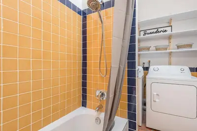 a bathroom with a shower and a tub and a toilet at Stylish Loft Retreat - Prime Location - Sleeps 8 in Montréal