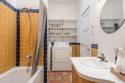 a bathroom with a sink and a washing machine at Stylish Loft Retreat - Prime Location - Sleeps 8 in Montréal